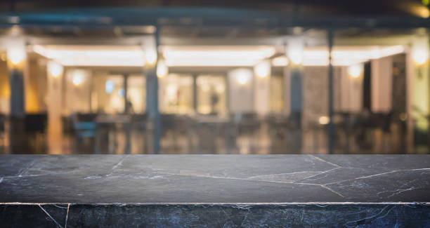 istock Stone table top and blurred bokeh cafe and coffee shop interior background with vintage filter - can used for display or montage your products. 844953338