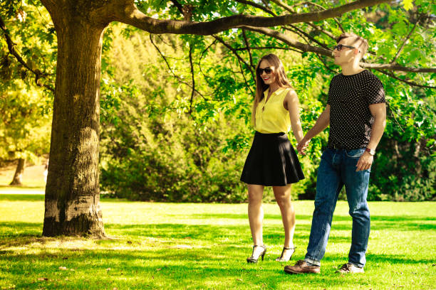 istock Couple holding hands in park. 844979560