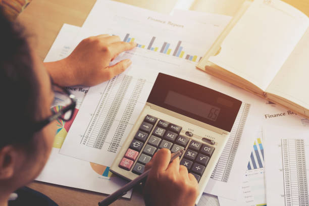 istock woman hand using calculator and writing make note with calculate,business concept 844985222