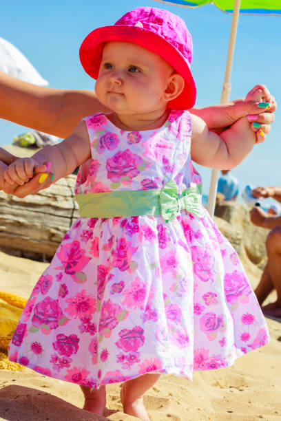 istock Child holding adult hands on beach 844991174