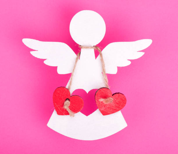 istock Christmas decorations of white angel two linked red hearts 844995218
