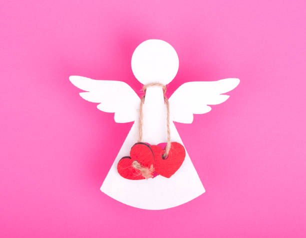istock Christmas decorations of white angel two linked red hearts 844995220
