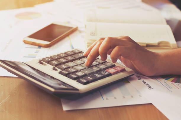 istock woman hand using calculator and writing make note with calculate,business concept 845006858