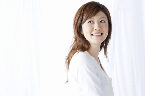 istock Women smile through the curtains 845013132