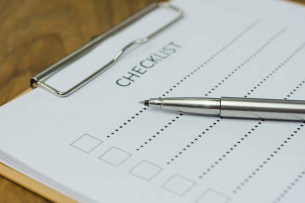 istock Checklist concept - checklist, paper and a pen with checklist word on wooden table 845021444