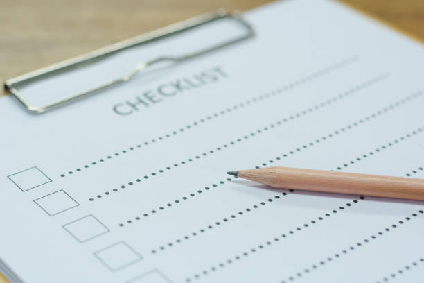 istock Checklist concept - checklist, paper and a pen with checklist word on wooden table 845021804