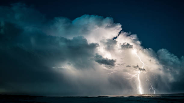 istock Lightning strikes out at sea at night. 845040064