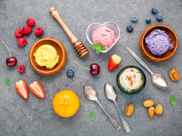 istock Flat lay ice cream with various fruits raspberry ,blueberry ,strawberry ,orange and cherry  setup on dark stone background . Summer and Sweet menu concept. 845052892