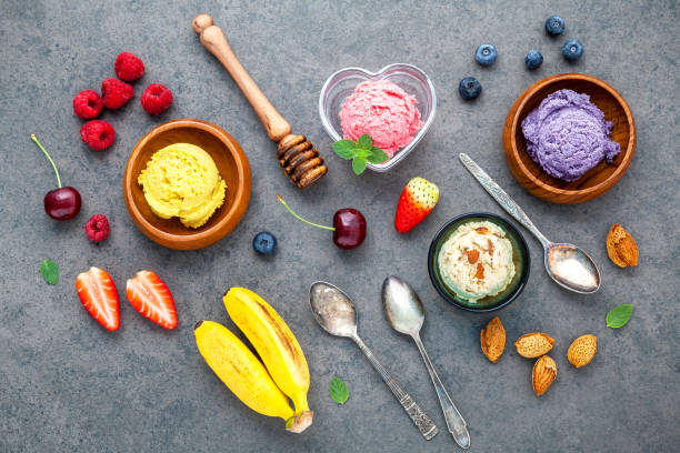 istock Flat lay ice cream with various fruits raspberry ,blueberry ,strawberry ,orange and cherry  setup on dark stone background . Summer and Sweet menu concept. 845053108