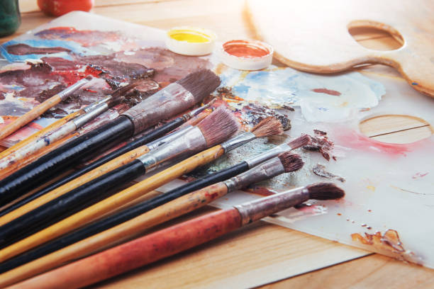 istock colorful paint palette with brushes 845060090