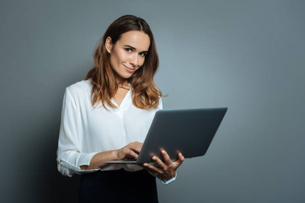 istock Delighted positive woman using her laptop 845078062