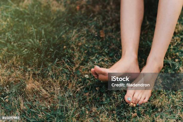 Bare Feet On A Meadow Stock Photo - Download Image Now - Grass, Foot, Barefoot