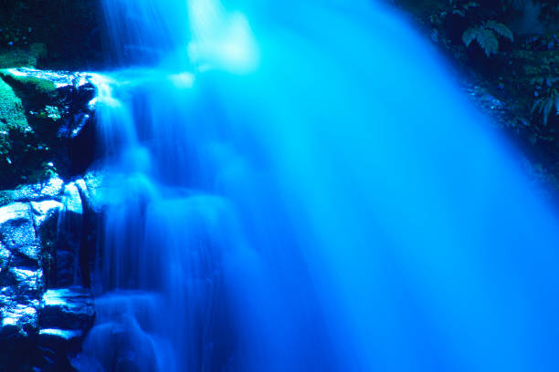 Close up of waterfall flowing over rocks into freshwater. Photographed in Tropical North Queensland, Australia.