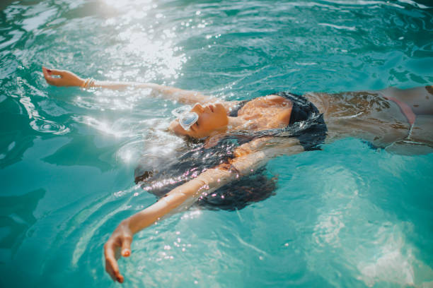 istock Young is relaxing in a swimming pool 845114756