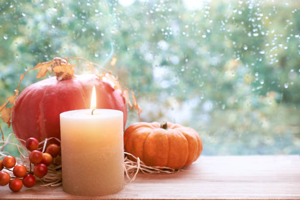 istock Burning candle, pumpkin and Fall decorations on a windowboard, space 845119696