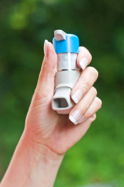 istock hand with asthma aerosol on nature background 845120062