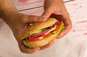 close-up a man holding a sandwich