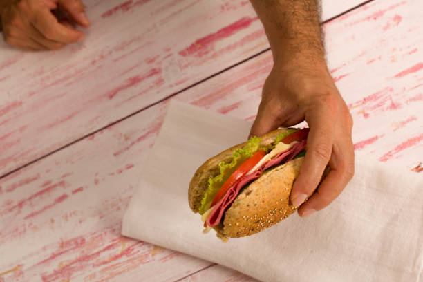 close-up man holding a sandwich