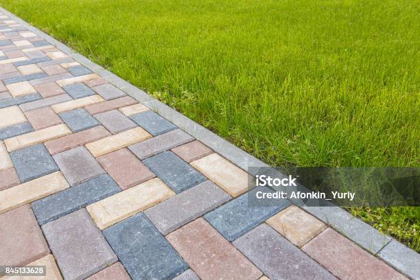 Road And Lawn Divided By A Concrete Curb Stock Photo - Download Image Now - Paving Stone, Sidewalk, Patio