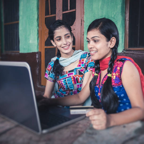 istock Happy sisters doing online shopping at home. 845160162