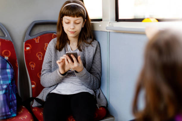 istock Young girl texting on phone in the bus 845163962