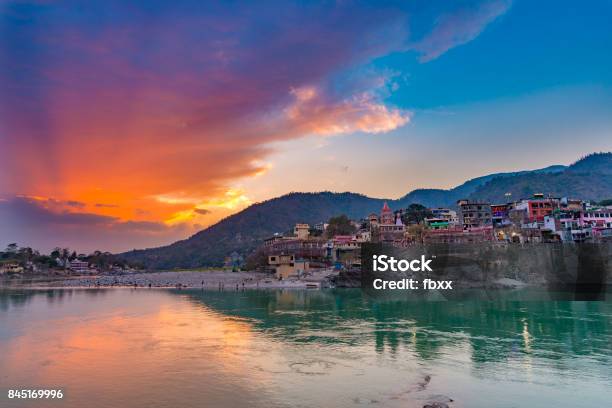 Dusk Time At Rishikesh Holy Town And Travel Destination In India Colorful Sky And Clouds Reflecting Over The Ganges River Stock Photo - Download Image Now