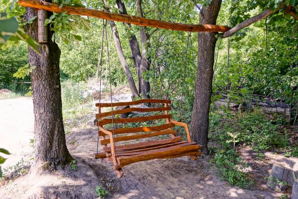 istock swing from a wooden brown bench 845180452