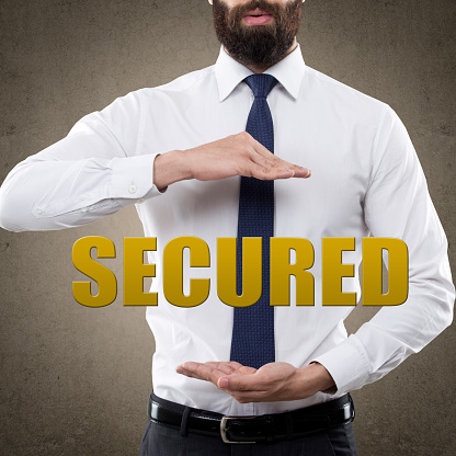 Businessman showing single word secured