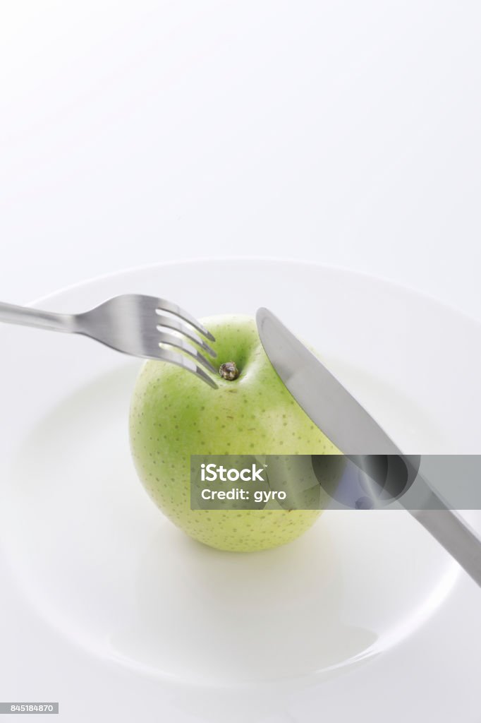 Green Apple with fork Apple - Fruit Stock Photo