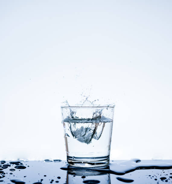 istock Ice with water splashing in the glass with reflection on mirror. 845194408