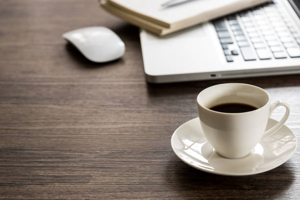 istock Black coffee on the office desk table with computer, silver pen. Business desk table top view with copy space concept. 845194690