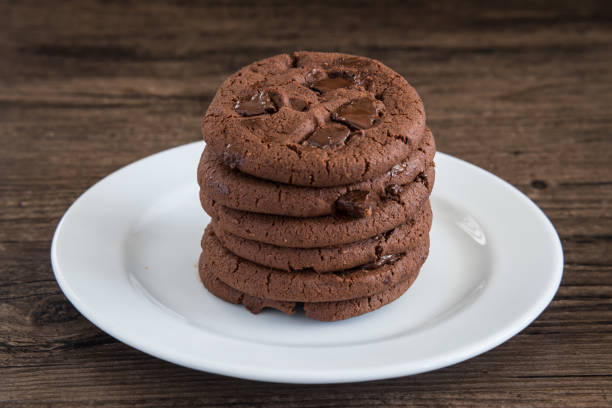 istock Dark Chocolate Cookies on white plate and wood table. 845195044