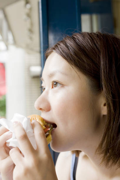 istock Woman eating a hamburger 845195706
