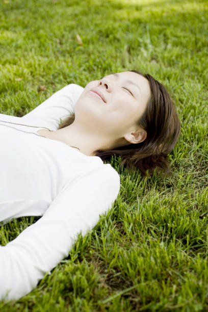istock Woman laying on the grass 845198018