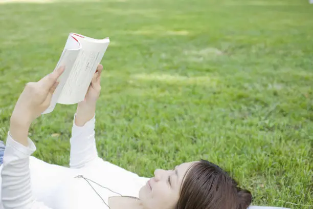 Girl reading a book slept on the grass