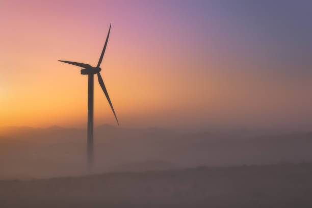 istock wind turbine silhouette at sunset 845198174