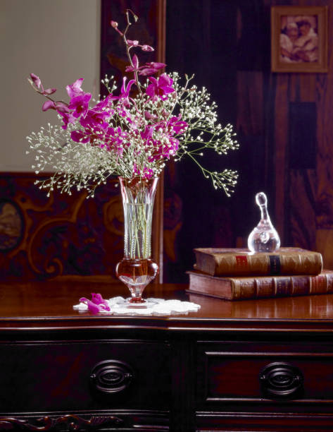 istock Vase arranged orchids placed on antique furniture 845201782