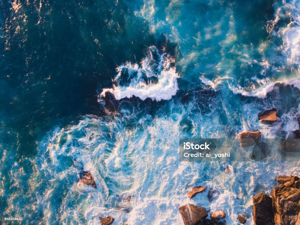 Rock and Water Aerial view of waves and some rocks. Sea Stock Photo