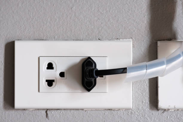 istock Electrical plug (left) and TV signal plug (right) on grey cement background 845212550