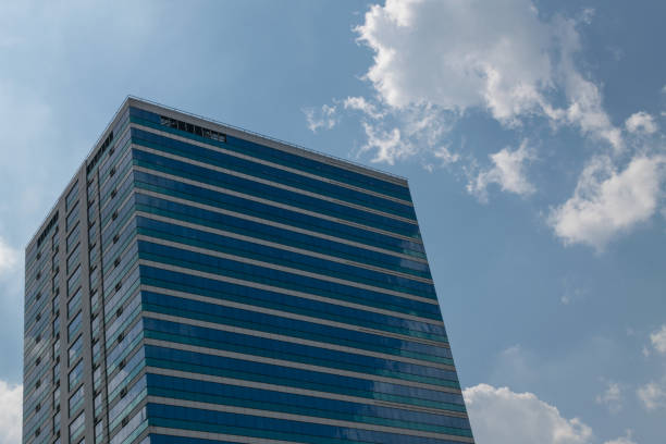 istock Big glass office building with blue sky and white cloud 845213088