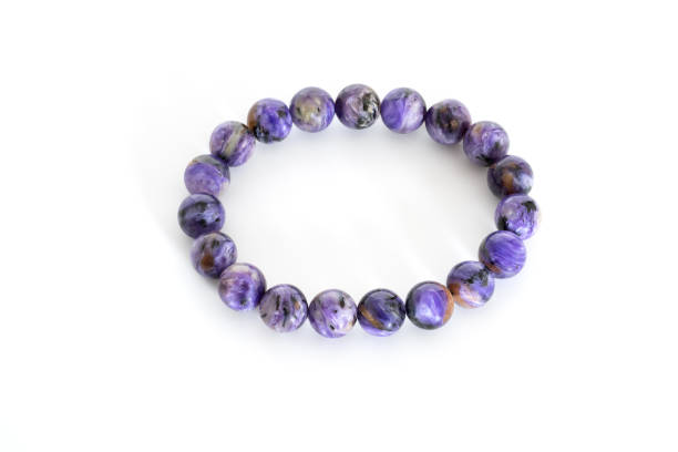 istock Charoid beads in bracelets on white background 845218434