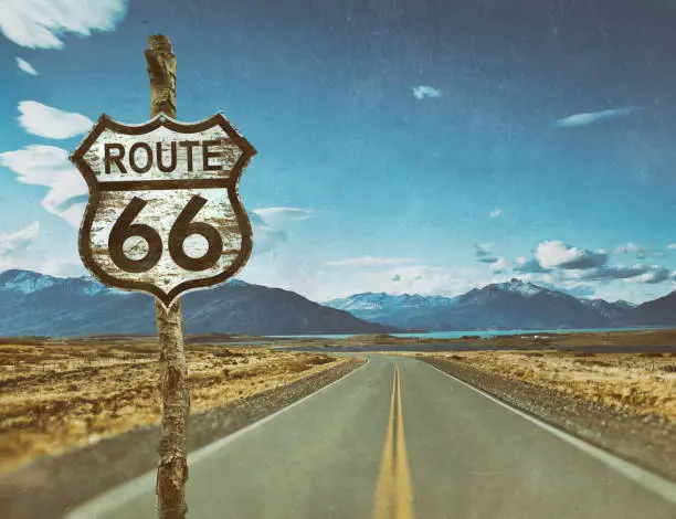 Highway sign for Route 66 on country road - photo with antique scratches