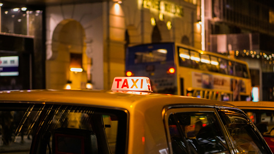 Taxi sign at night blur view in pub and bar nightlife area. Abstract safty drunk don't drive