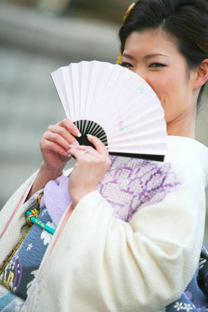 istock Women wearing a kimono with a fan 845246898