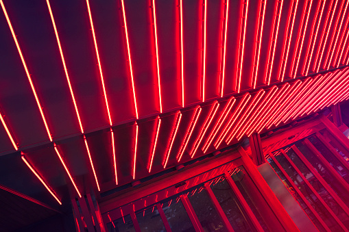 Detail of an entrance lit with red neon light.