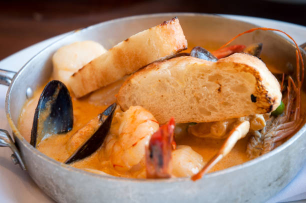 istock Frying pan with seafood in garlic sauce and toasted bread. 845266992