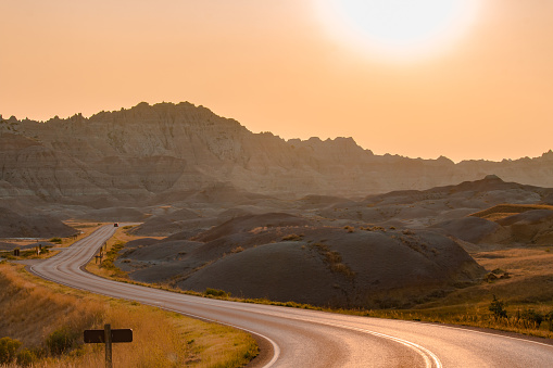 Scenic road at sunset in Badlands National Park.