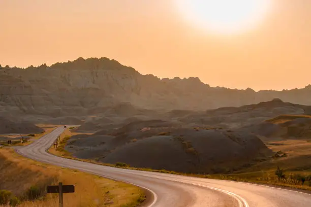 Photo of Scenic road at sunset in Badlands National Park.