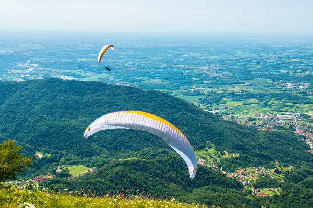 istock Two paragliders fly over the hills on a sunny day 845271652