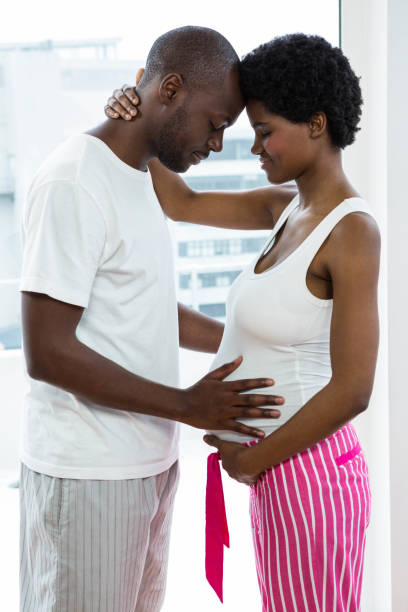 istock Pregnant couple cuddling each other 845274010